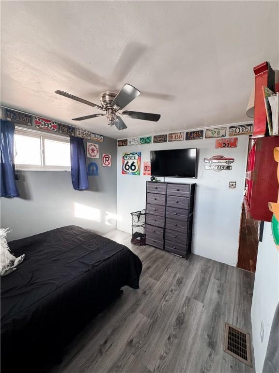 bedroom featuring hardwood / wood-style flooring and ceiling fan