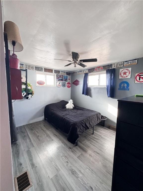 bedroom with hardwood / wood-style floors and ceiling fan