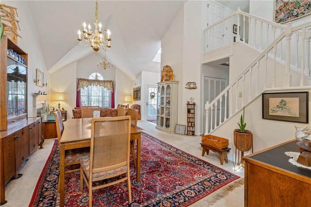 dining room with high vaulted ceiling and a chandelier