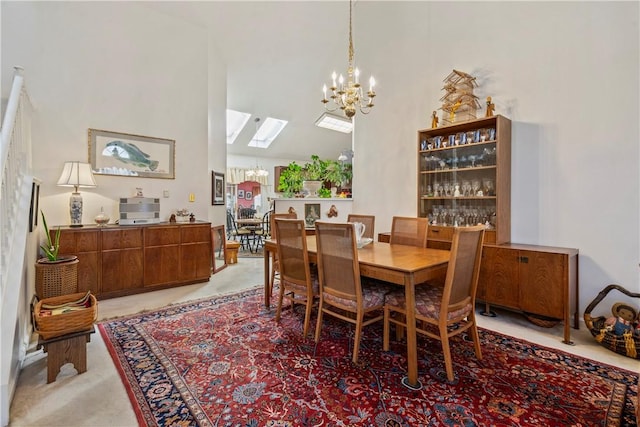 dining space featuring an inviting chandelier and high vaulted ceiling