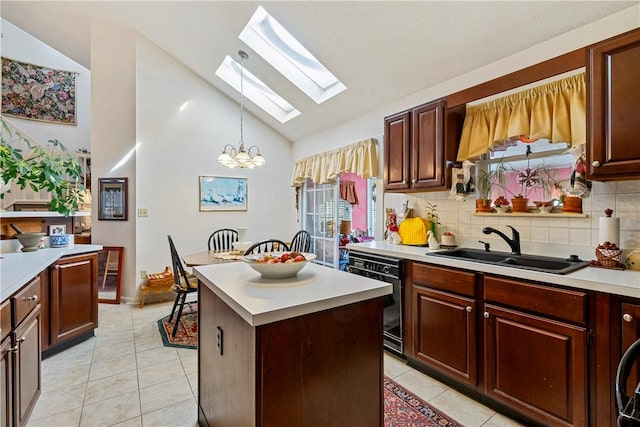 kitchen featuring pendant lighting, sink, light tile patterned flooring, and a kitchen island