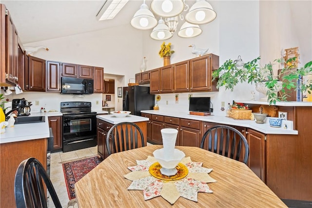 kitchen featuring high vaulted ceiling, sink, a chandelier, light tile patterned floors, and black appliances