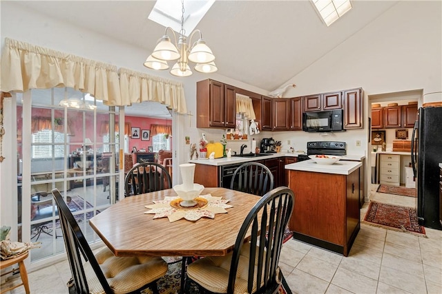 kitchen featuring sink, an inviting chandelier, a center island, pendant lighting, and black appliances