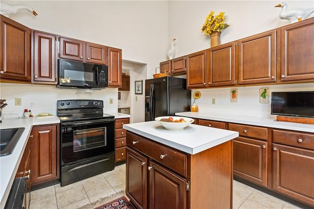 kitchen with light tile patterned flooring, a kitchen island, sink, a high ceiling, and black appliances