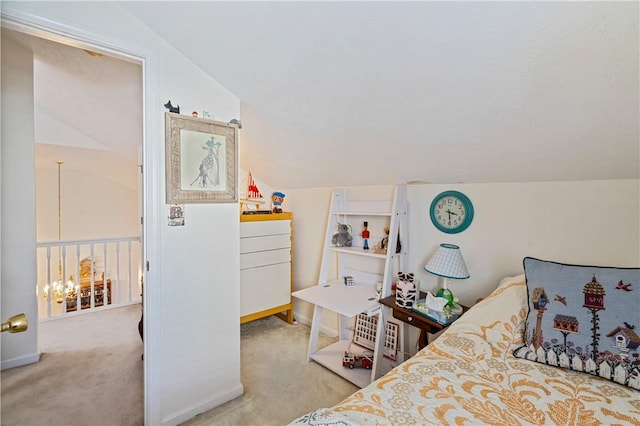 carpeted bedroom featuring a chandelier and vaulted ceiling