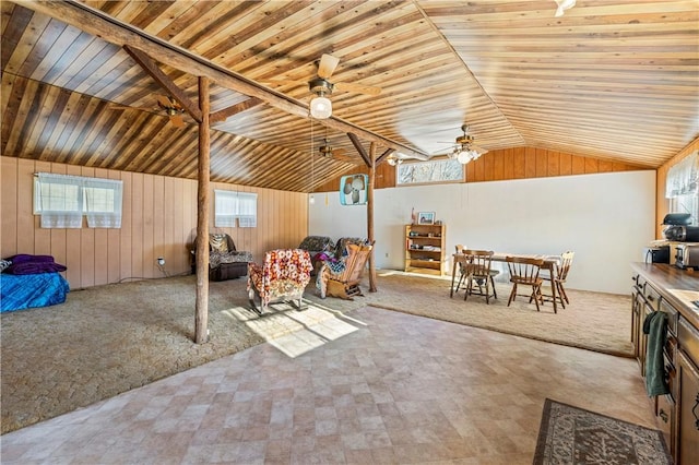 interior space with plenty of natural light, wooden ceiling, lofted ceiling, and ceiling fan