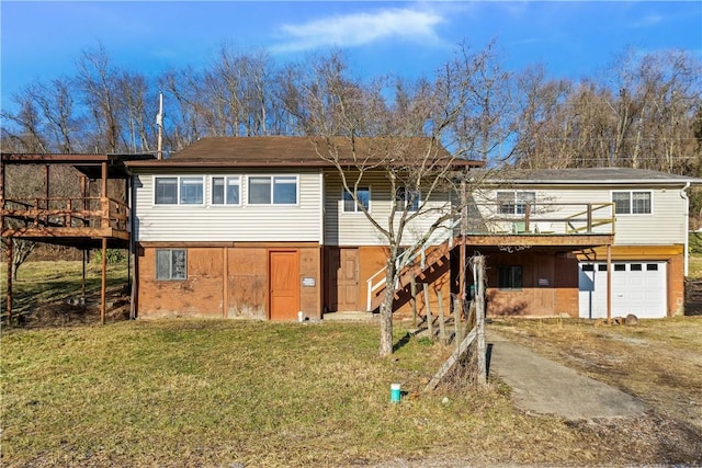 view of front of property with a garage, a front lawn, and a deck