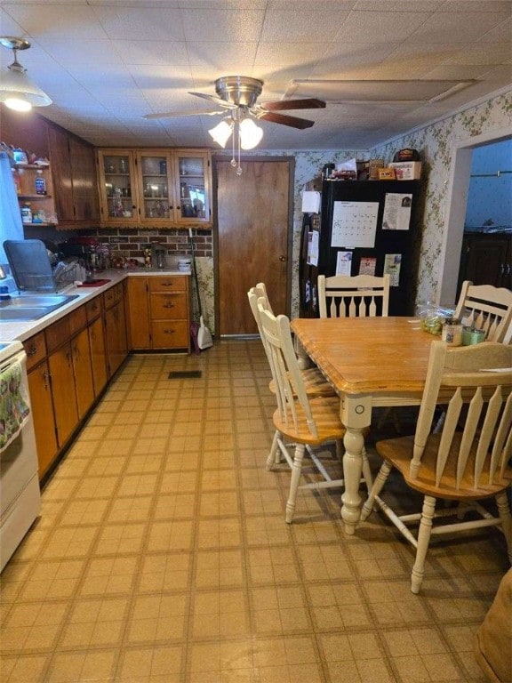 kitchen featuring sink, white electric range, and ceiling fan