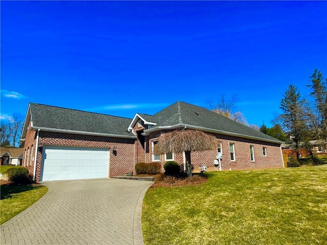 ranch-style home featuring decorative driveway, brick siding, a shingled roof, a front yard, and a garage