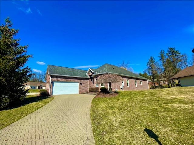 view of front of property with a garage, a front lawn, decorative driveway, and brick siding