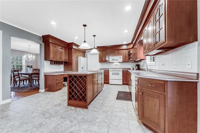 kitchen with a kitchen island, decorative light fixtures, sink, backsplash, and white appliances