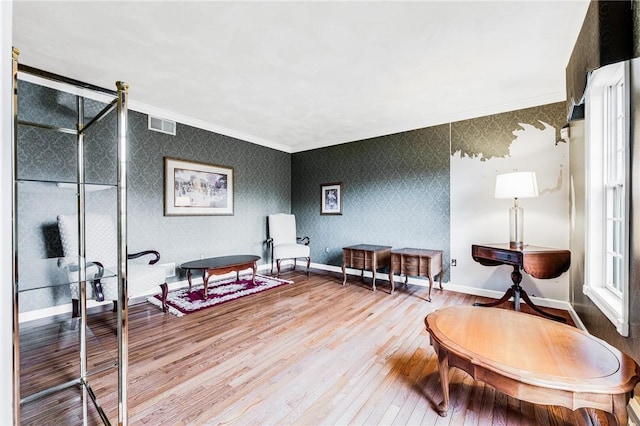 sitting room featuring hardwood / wood-style floors and ornamental molding