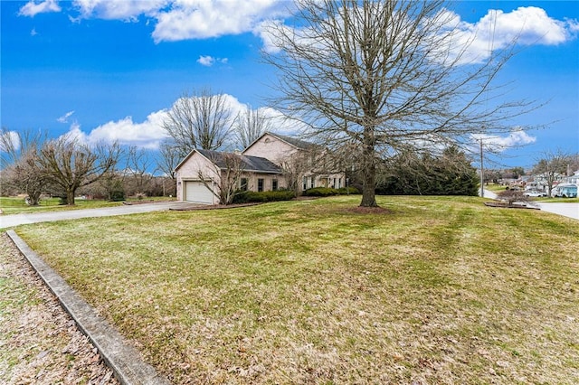 view of front of house with a garage and a front lawn