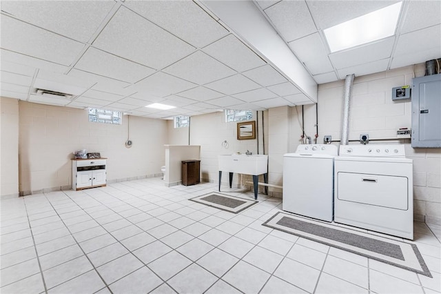 laundry area with separate washer and dryer, sink, and electric panel