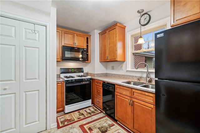 kitchen with hanging light fixtures, sink, and black appliances