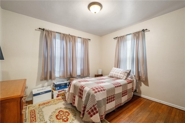 bedroom with dark hardwood / wood-style floors