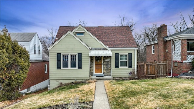 bungalow-style house featuring a yard