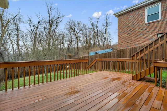 wooden terrace with a lawn