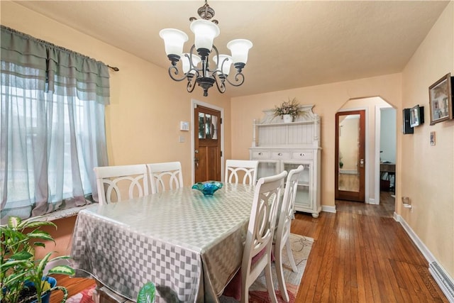 dining room with an inviting chandelier and dark hardwood / wood-style flooring