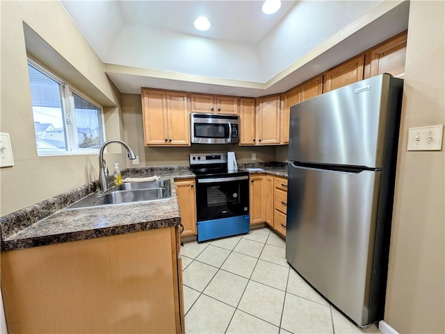 kitchen featuring stainless steel appliances, light tile patterned flooring, and sink