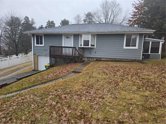 view of front of property with a garage and a sunroom