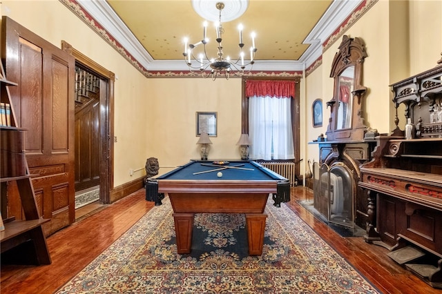 rec room with dark hardwood / wood-style flooring, pool table, ornamental molding, and a chandelier