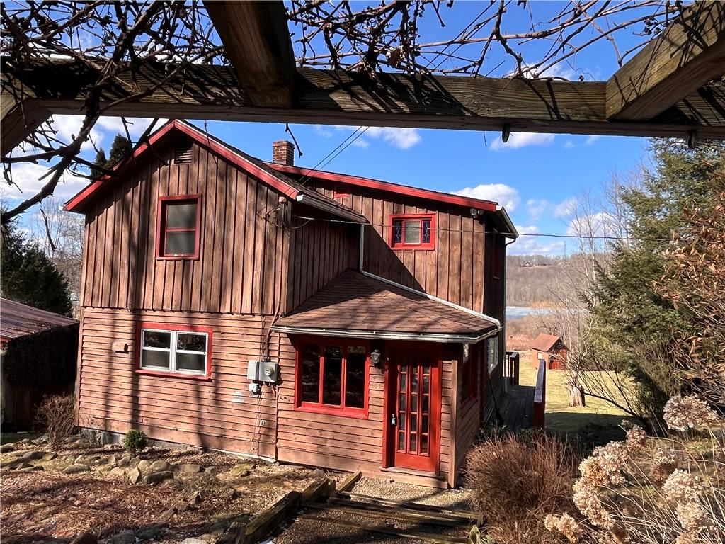 55 Elm St, Stoneboro, PA 16153 - rear view of house featuring board and batten siding and a chimney