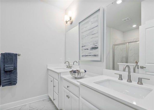 bathroom featuring vanity and a shower with shower door