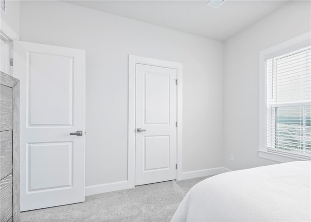 bedroom featuring light carpet