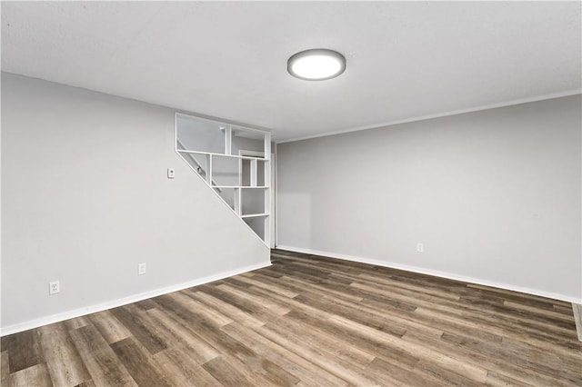 unfurnished room featuring dark hardwood / wood-style flooring and crown molding