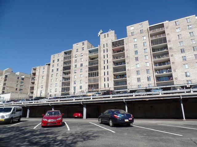 view of apartment building / complex with covered parking