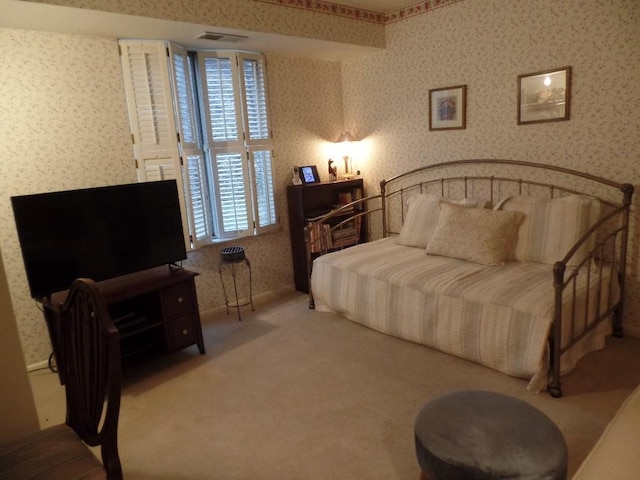 carpeted bedroom with wallpapered walls