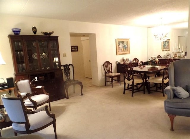 sitting room with a chandelier and carpet flooring
