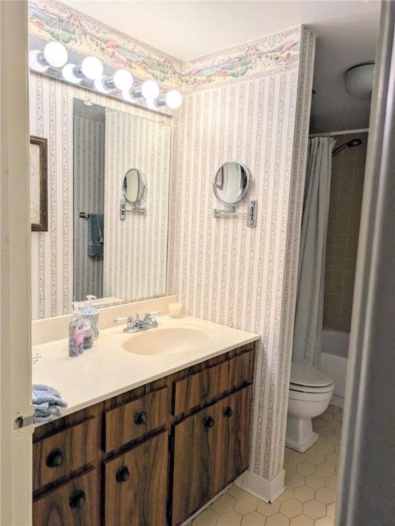 bathroom featuring tile patterned flooring, vanity, toilet, shower / bath combo, and wallpapered walls