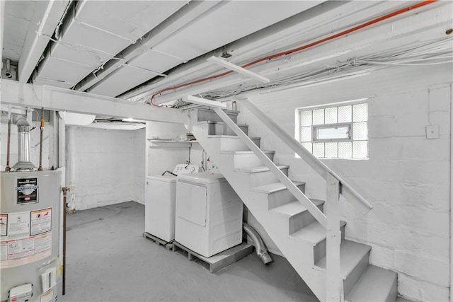 basement featuring water heater and washer and clothes dryer