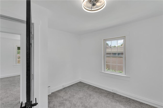 unfurnished room featuring light colored carpet