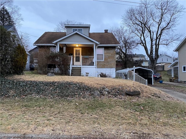 view of front of home with a carport and a porch