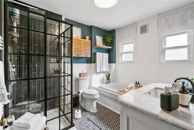 bathroom with a tub to relax in, vanity, and toilet