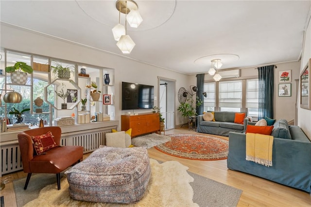 living room with plenty of natural light, radiator heating unit, and an AC wall unit