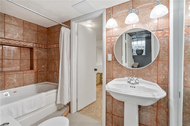 bathroom featuring tile walls and shower / tub combo