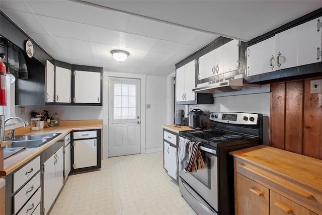 kitchen with sink, electric range, and white cabinets