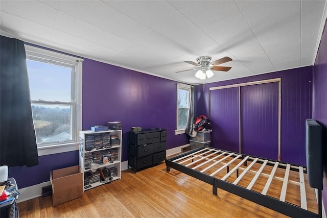 bedroom with wood-type flooring and ceiling fan