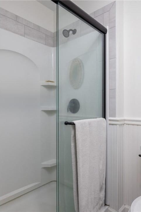 bathroom with a shower with door