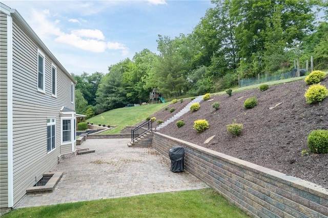 view of yard featuring a patio area and a playground