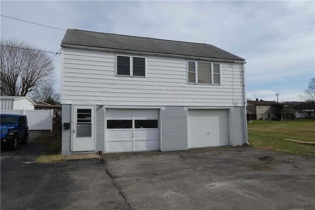 garage with driveway and fence