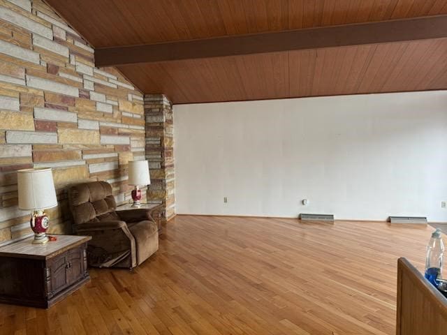 sitting room featuring lofted ceiling with beams, wooden ceiling, baseboard heating, and wood finished floors