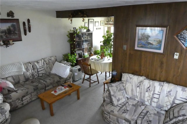 carpeted living room with wooden walls