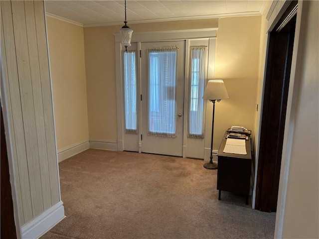 interior space featuring carpet floors, ornamental molding, and baseboards