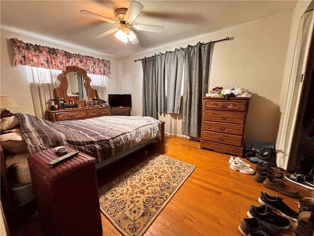 bedroom featuring a ceiling fan and wood finished floors