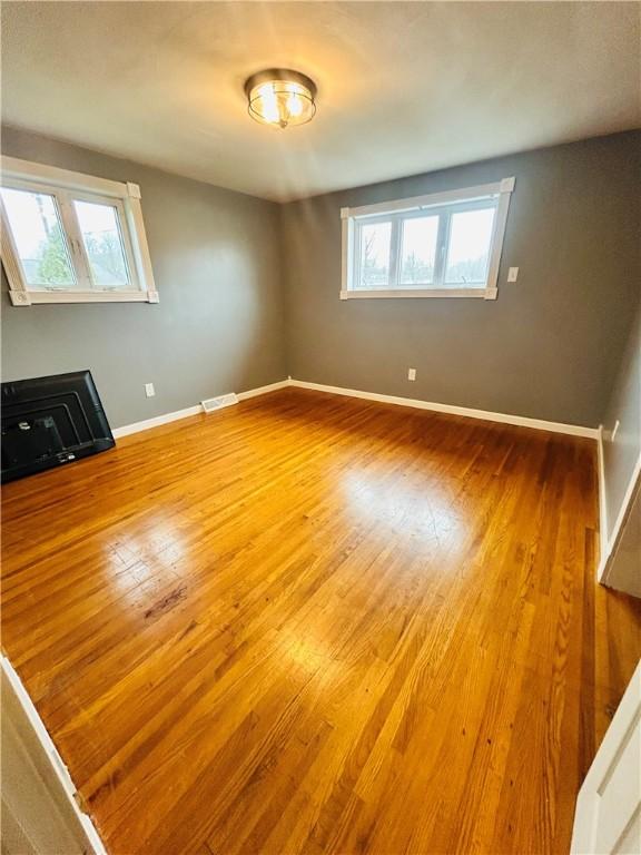 unfurnished room with hardwood / wood-style floors